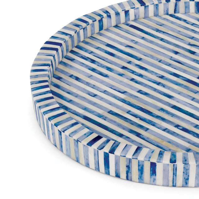 Individual pieces of natural and indigo-colored bone form this round tray, which is pretty enough to stand as an...