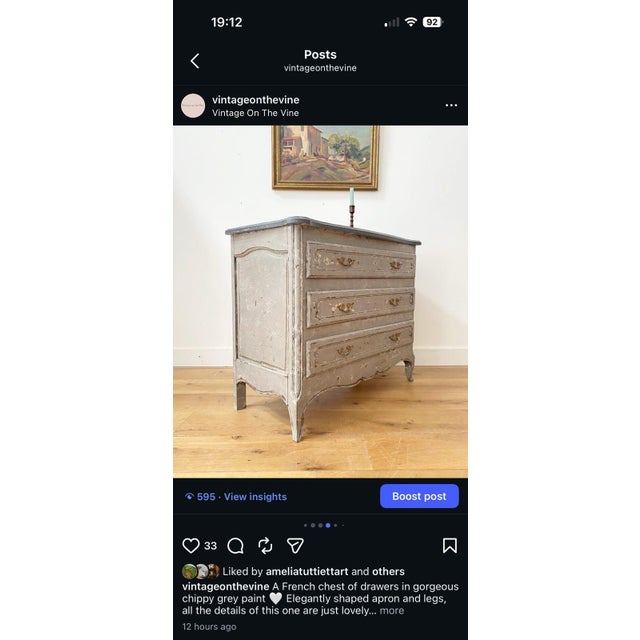 A shapely French chest of drawers, in gorgeous chippy grey paint. with elegantly carved apron and legs, brass fixtures and...