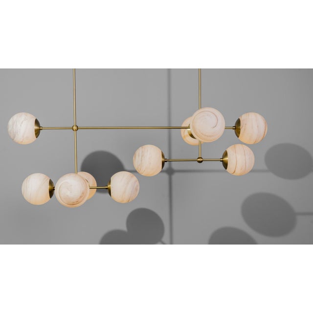 Armstrong Linear Chandelier, Brass and Glass, Contemporary, in Stock Offered by Schwung Armstrong Linear captures a sense...