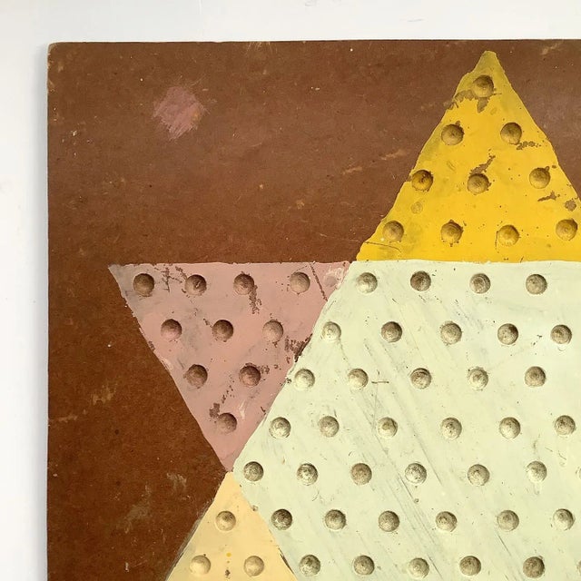 Vintage hand painted folky Chinese checker game board on masonite with hanger on back. Game board has chips, scratches,...