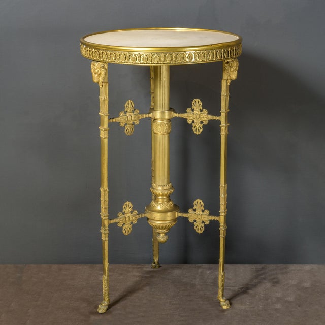 Important a late ronde table, made in France entirely of gilded bronze. Features a circular top of white Carrara marble,...