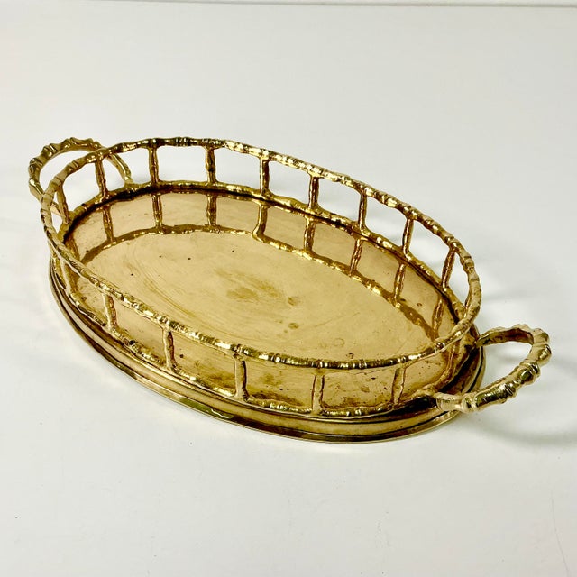 Vintage Home is pleased to present this oval brass gallery tray. It features a faux bamboo brass gallery and handles. The...