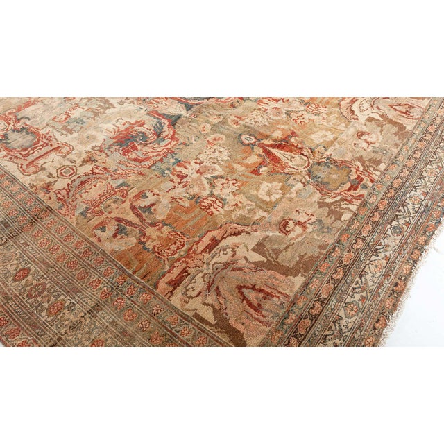 An exceptional example from our collection of Early 20th Century Persian Senneh rugs. The striated tan field with lush...