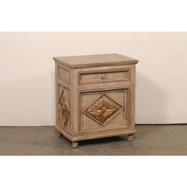A Spanish small-scale painted wood cabinet from the mid 20th century. This mid-century side chest from Spain, crafted from...