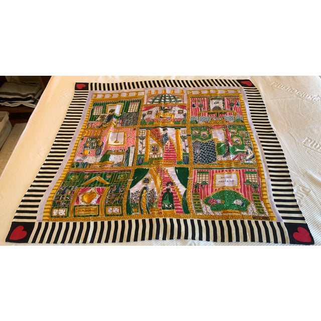 This vintage Moschino silk scarf features a vibrant multi-panel architectural room collage print framed by black-and-white...