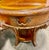 This is a set of three vintage wooden tables consisting of a large oval coffee table and two matching end tables. They...