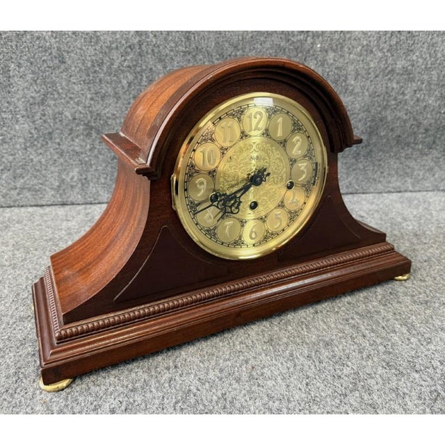 This vintage Sligh solid mahogany mantel clock features a warm mahogany case with a gracefully arched top and a detailed...