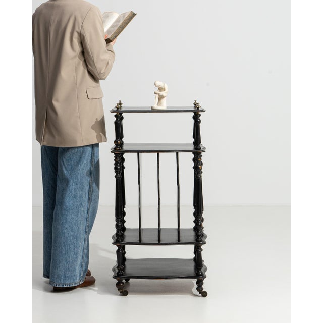 A 19th century French étagère from the Napoleon III period, crafted in wood with a black patinated finish and a vertical...