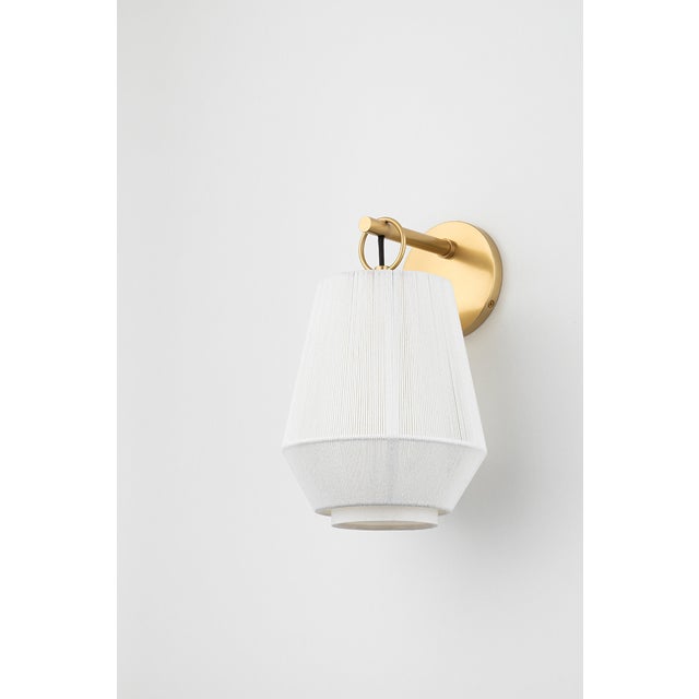 Debi plays with layers, texture, and tone to reveal a multi-dimensional silhouette. A linen drum shade serves as the base,...
