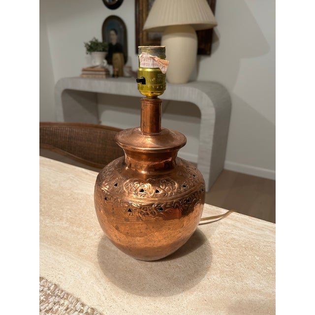 This is a charming copper lamp. The lamp is in working order. The shade is not original but silk like.