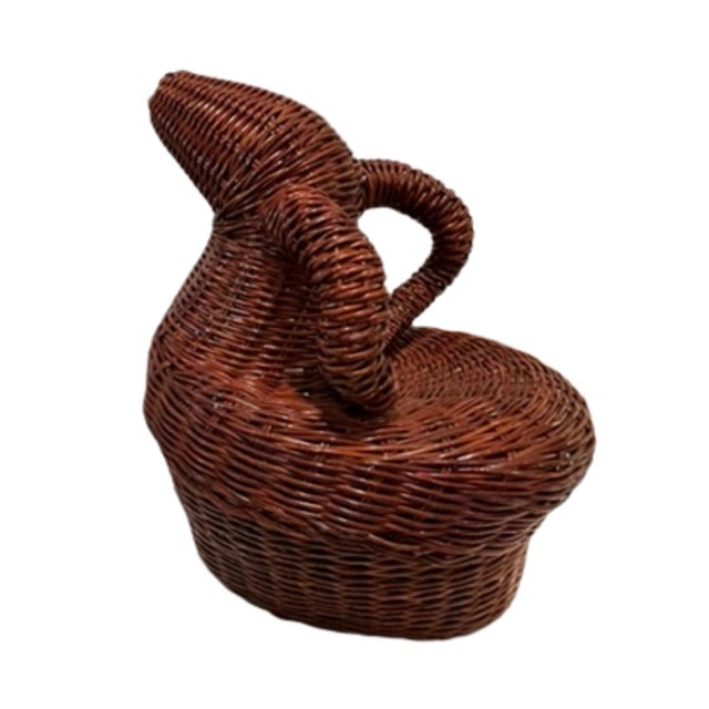 Reddish brown color wicker basket with top lid shaped as a ram's head with bighorns. Interior of bottom of basket measures...
