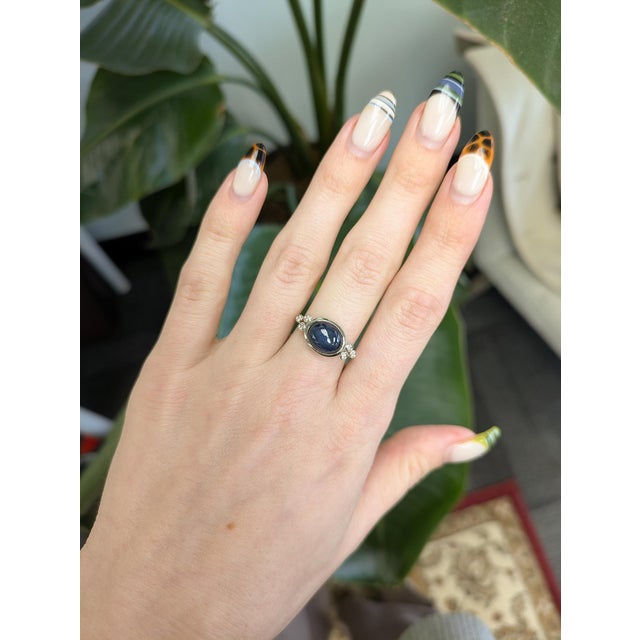 A striking 6ct oval star sapphire set in solid 14k gold, glowing with natural asterism. Finished with sparkling natural...