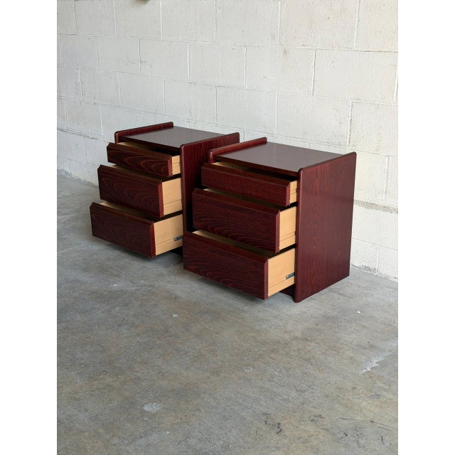Beautiful pair of vintage Danish Modern nightstands crafted in richly toned wood with striking grain throughout. The...