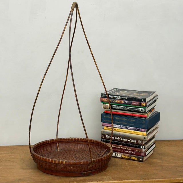 "About This Piece About This Piece This tall bamboo basket captures elegance in simplicity, pairing a finely woven tray...