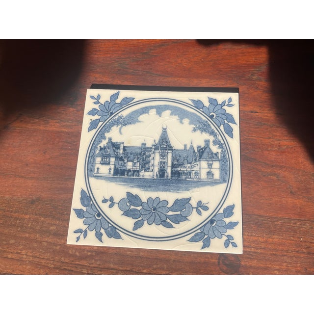 A pretty Biltmore tile trivet in blue & white with a hanger on back to hang, or cork to use as a trivet. A well known...