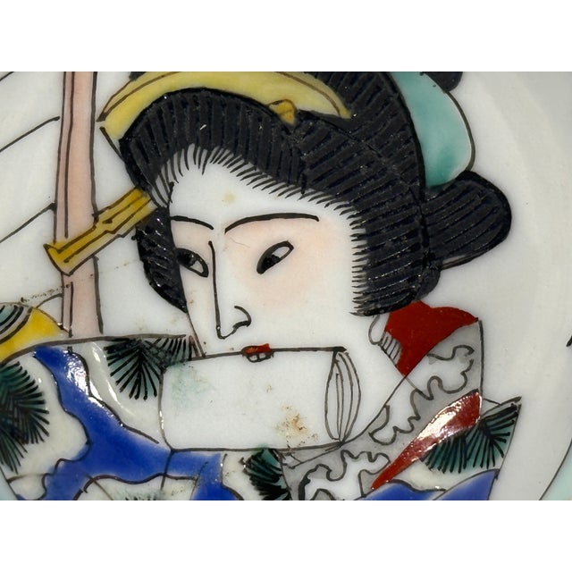 Japanese Porcelain Geisha Sake Cup for your consideration. The cup measures approx. 1 1/4 inches tall. Top diameter...