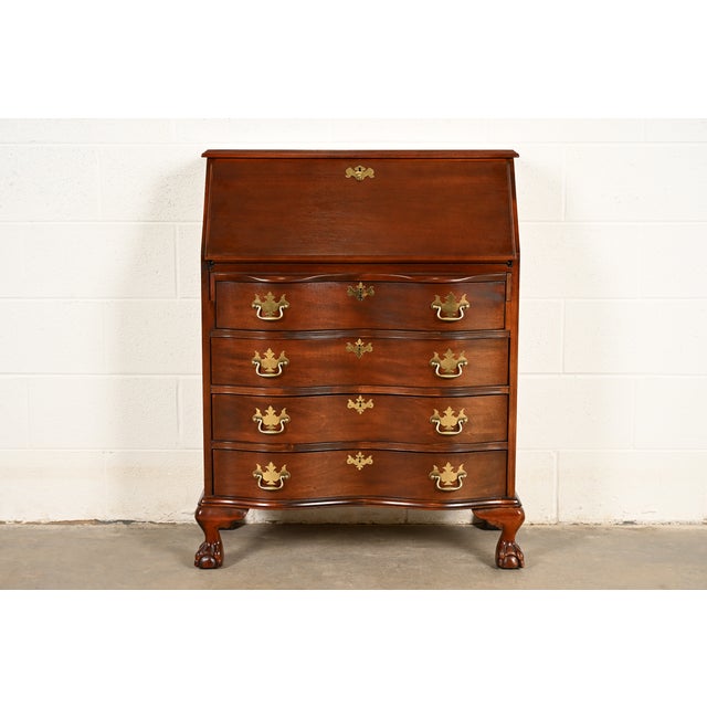 An outstanding Chippendale or Georgian style serpentine front bureau with drop front secretary desk In the manner of Baker...