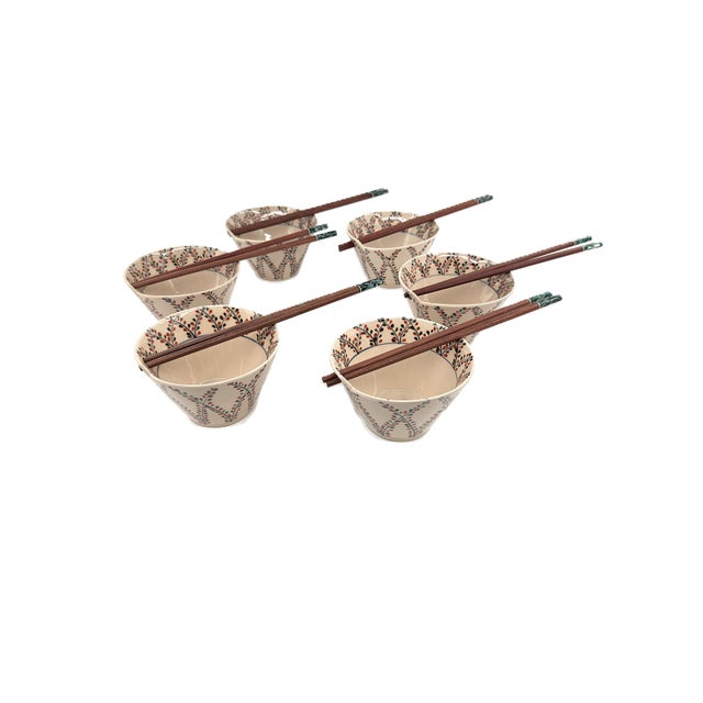 A beautiful set of six Bat Trang ceramic bowls, handcrafted in Vietnam and decorated with a delicate, rhythmic botanical...
