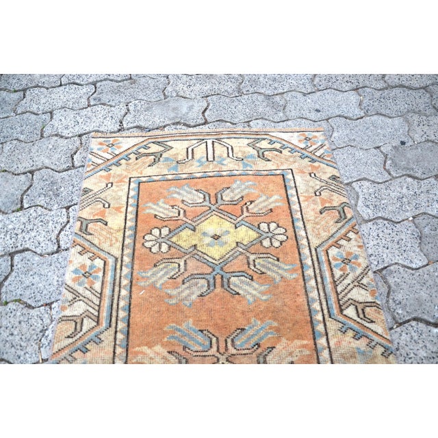 This is a vintage Turkish Oushak rug from the 1960s. The piece was hand-knotted.