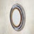 A French round wall mirror from the 1970s, defined by contrast, color, and a distinctly graphic sense of composition. The...