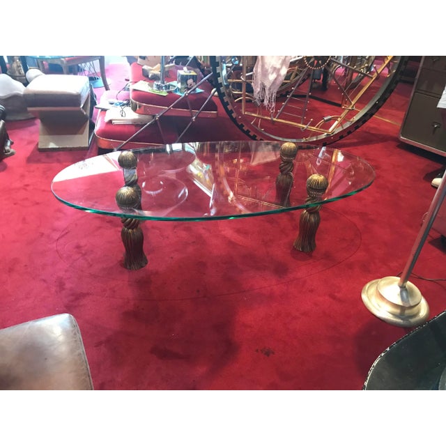 Large oval 1/2’ inch glass table with 4 golden tassels legs in great condition no nicks.