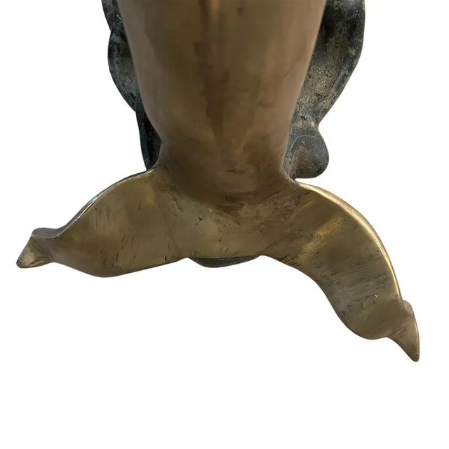 This charming brass dolphin supports the glass on this stylish coffee table - in turn, s/he is resting on a patinated...