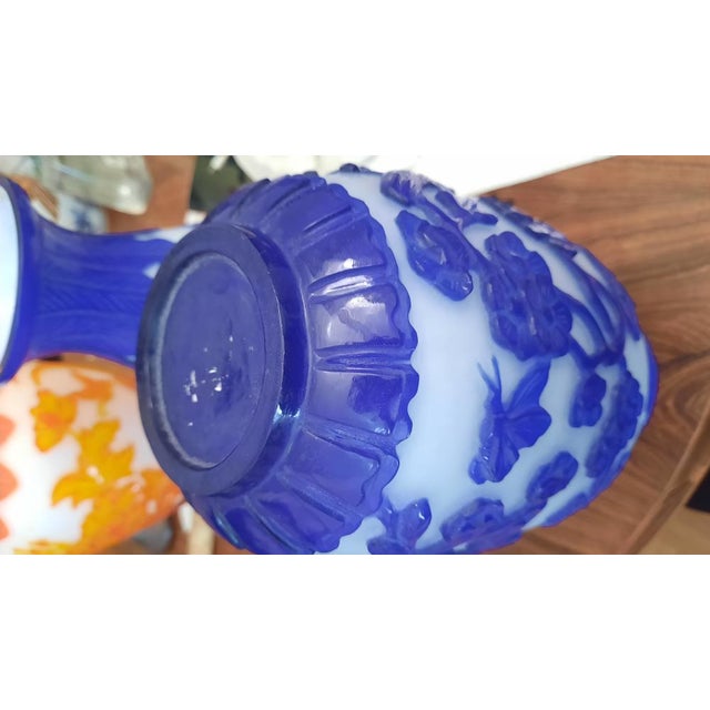 Impressive coloured glass vases with cameo designs of flowers, birds and small animals.