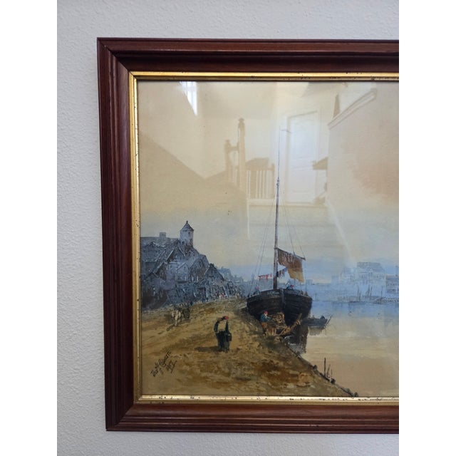 This antique 1917 watercolor painting attributed to Thomas J. Caparn captures a quiet harbor scene with moored boats and...