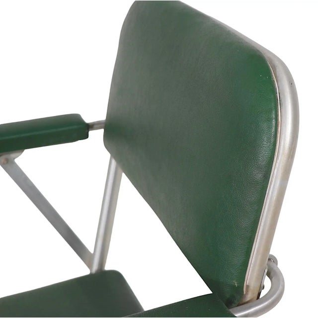 Chic set of four folding lounge chairs by Warren MacArthur. The chairs feature green vinyl backs and seats and the...