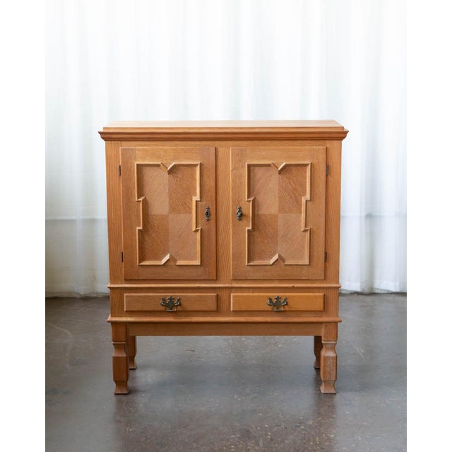 A substantial Danish oak cabinet by Henning Kjærnulf, produced in the 1970s. At 47 inches tall and just over 41 inches...