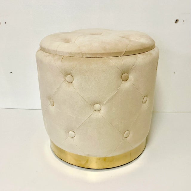 This is a gorgeous vintage stool. It features a cream velvet upholstery with tufted design. The cylinder shape sits on a...