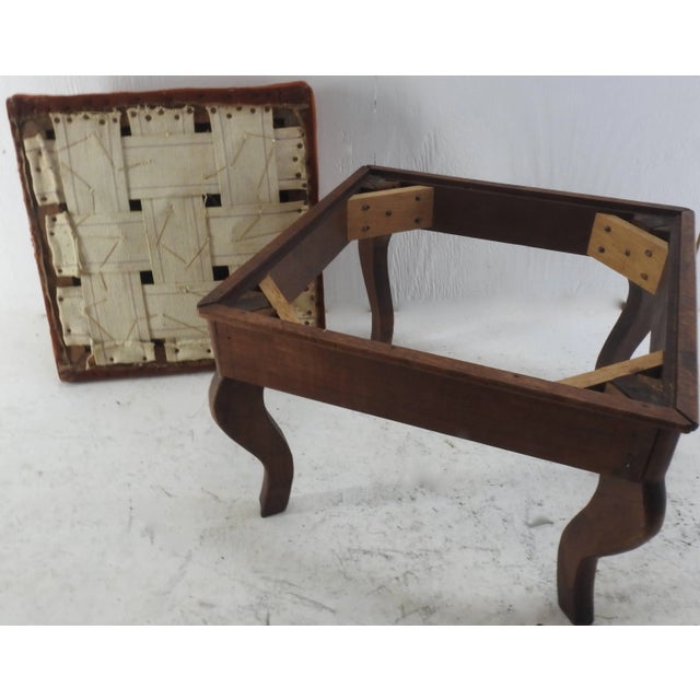 Soft pink flowers sit atop the rust colored needlepoint cushion of this stool from France. The graceful legs curve upward...