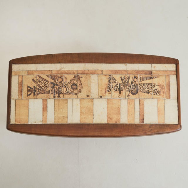 A French ash wood and ceramic coffee table by Roger Capron, crafted in Vallauris during the 1960s. The rectangular top is...
