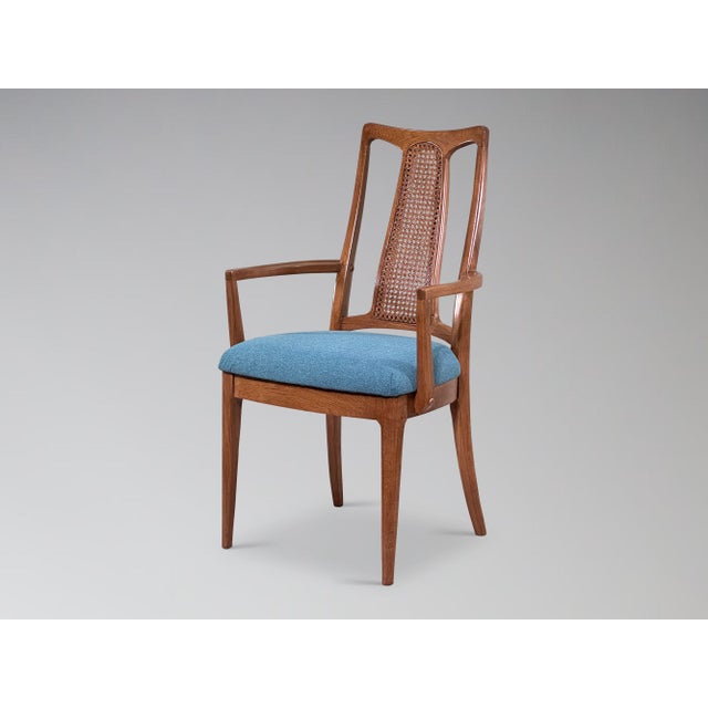 A set of 6 restored vintage cane back walnut dining chairs, comprised of 2 armchairs and 4 armless. Having been fully...