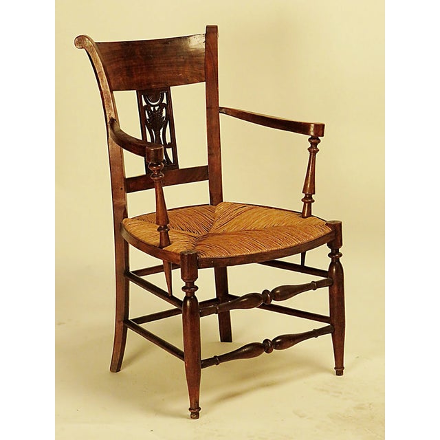 Directoire French provincial walnut armchair. Circa 1830. Period: 19th Century Region: Italy Materials: Wood Condition:...