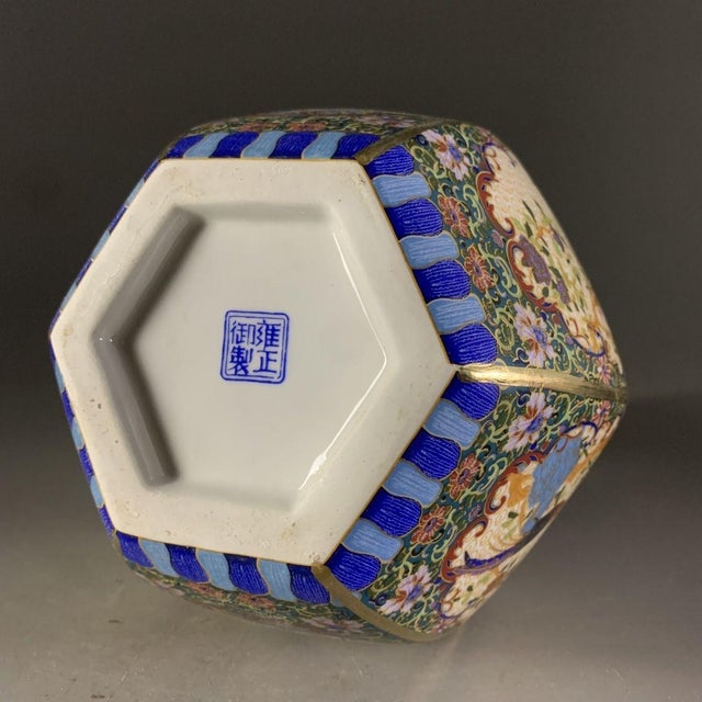 This beautiful vase features a classic hexagonal form with a tall, faceted neck and a bulbous body that tapers down to a...