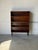 This sleek open shelf bookcase features three spacious tiers for storage and display. Elevated on dark tapered legs, it...