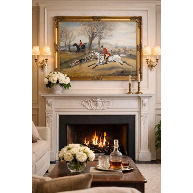 This large and dynamic oil on canvas painting depicts a classic fox hunt scene, with riders in traditional red coats...
