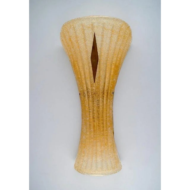Barovier &Toso, Venice. A pair of giant wall lamps in fluted mouth-blown art glass and brass. Italian design, 1960s....