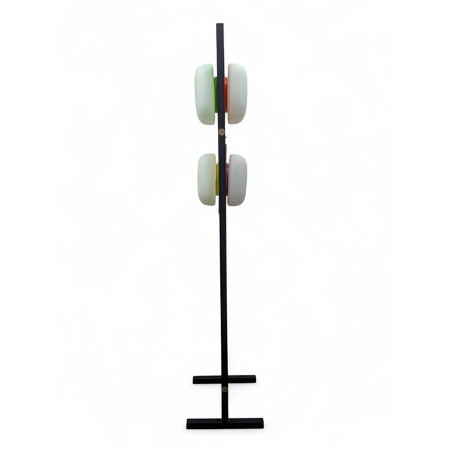 This designer floor lamp stands out for its minimalist black metal ladder structure supporting four opalescent glass shell...