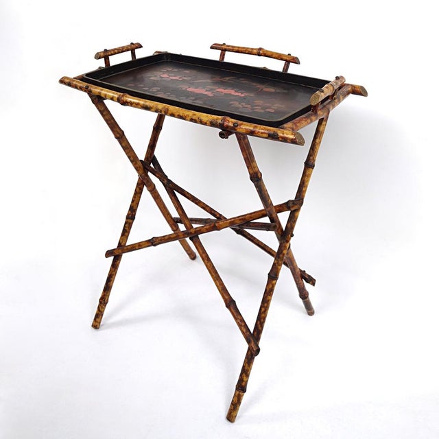 Very refined tray table with removable tray with oriental origins, probably from 1920s China. The frame looks pleasantly...