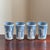 Offering a striking vintage set of four Wedgewood blue tumblers featuring elegant Grecian-style figures, decorative...