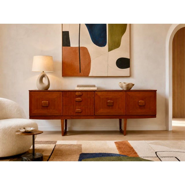 Mid Century Modern Teak Credenza by Stonehill, Made in England, c. 1960’s. This long and stunning piece is highlighted by...