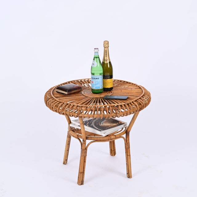 Outstanding Mid-Century round coffee table in curved bamboo and rattan. This lovely piece was designed in italy in the...