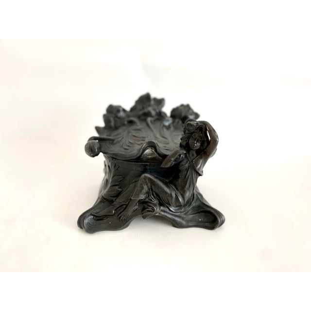 Clara Pfeffer (active ca. 1900), sculptural Art Nouveau metal covered box modeled with poppies and seated woman to lid and...