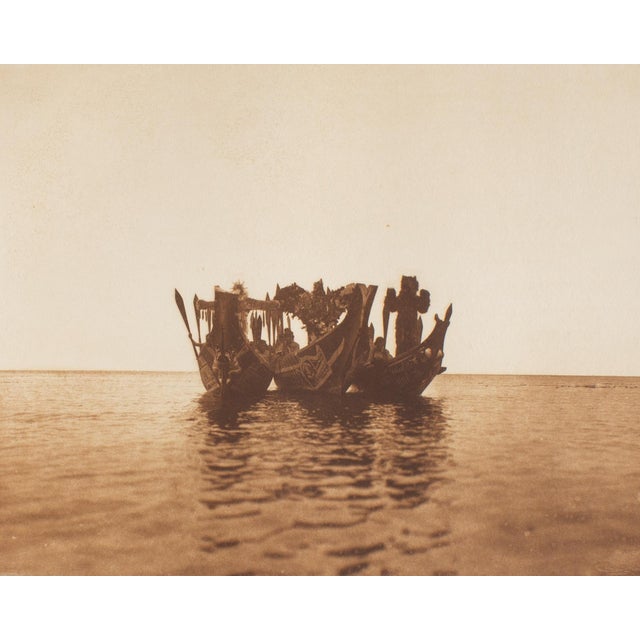 A photogravure restrike after a photograph by American photographer Edward Curtis (1868-1952). Titled "Masked Dancers in...