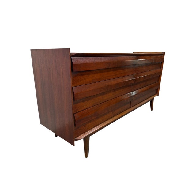 Elevate your bedroom with this stunning 1960’s Mid-Century Modern Lane 1st Edition walnut dresser, a true icon of American...