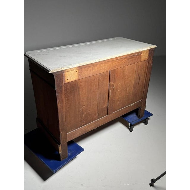 Louis Philippe style commode/chest of drawers. Crafted from solid oak. Veneered with mahogany and topped with a white...