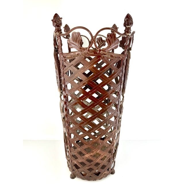 This antique cast iron umbrella stand showcases intricate Victorian-era design elements, perfect for adding a touch of...