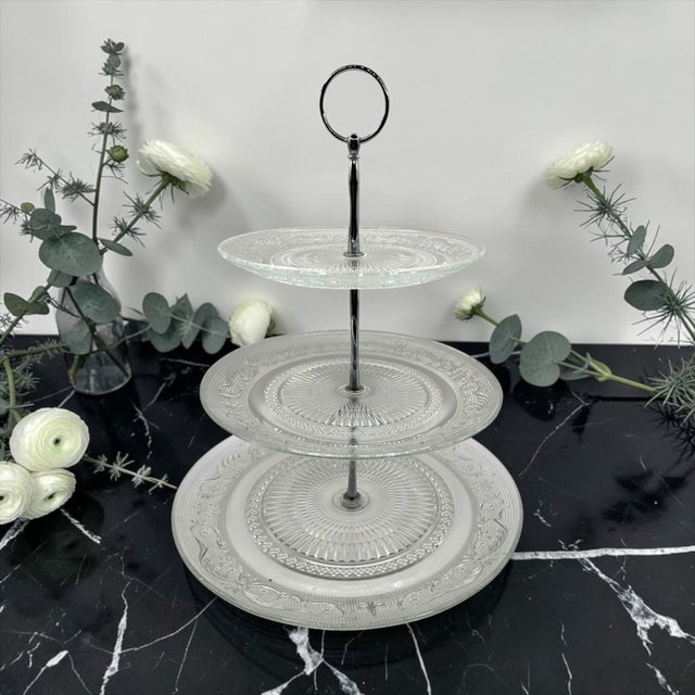 Elevate your next gathering with timeless, classic charm. This exquisite 3-tier clear glass serving stand features...